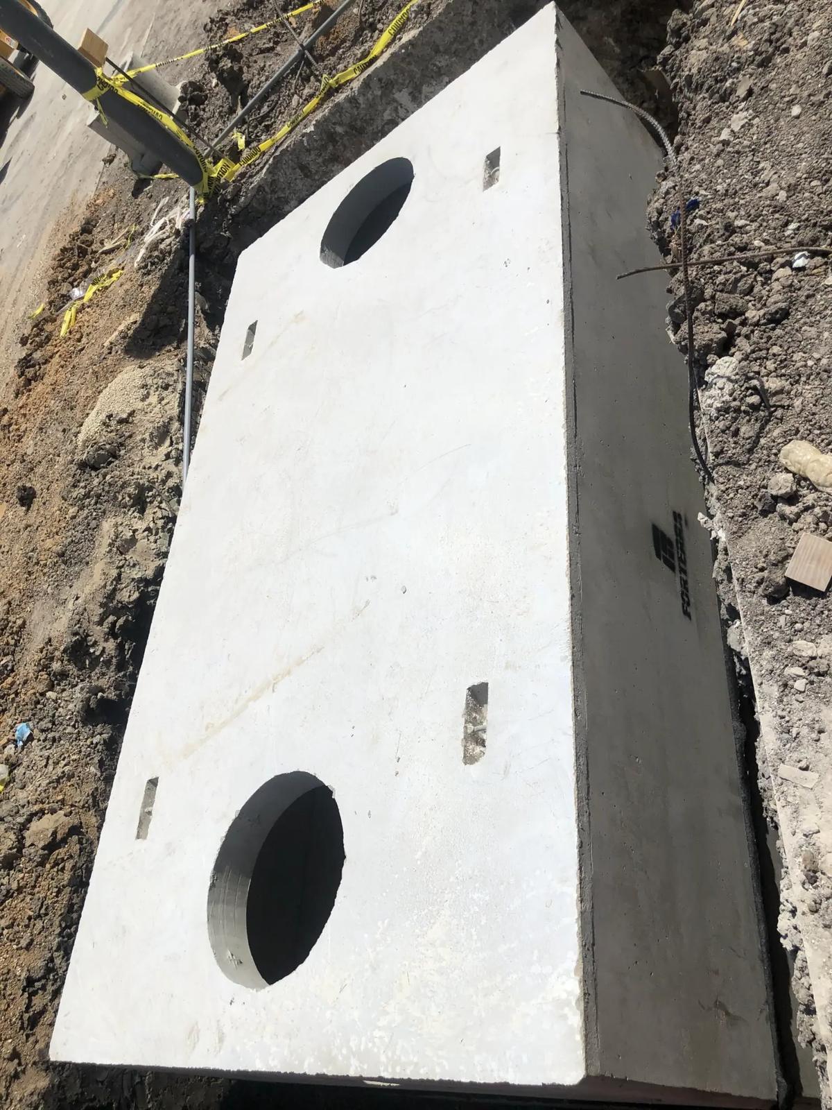 Concrete grease interceptor set in place for a commercial kitchen
