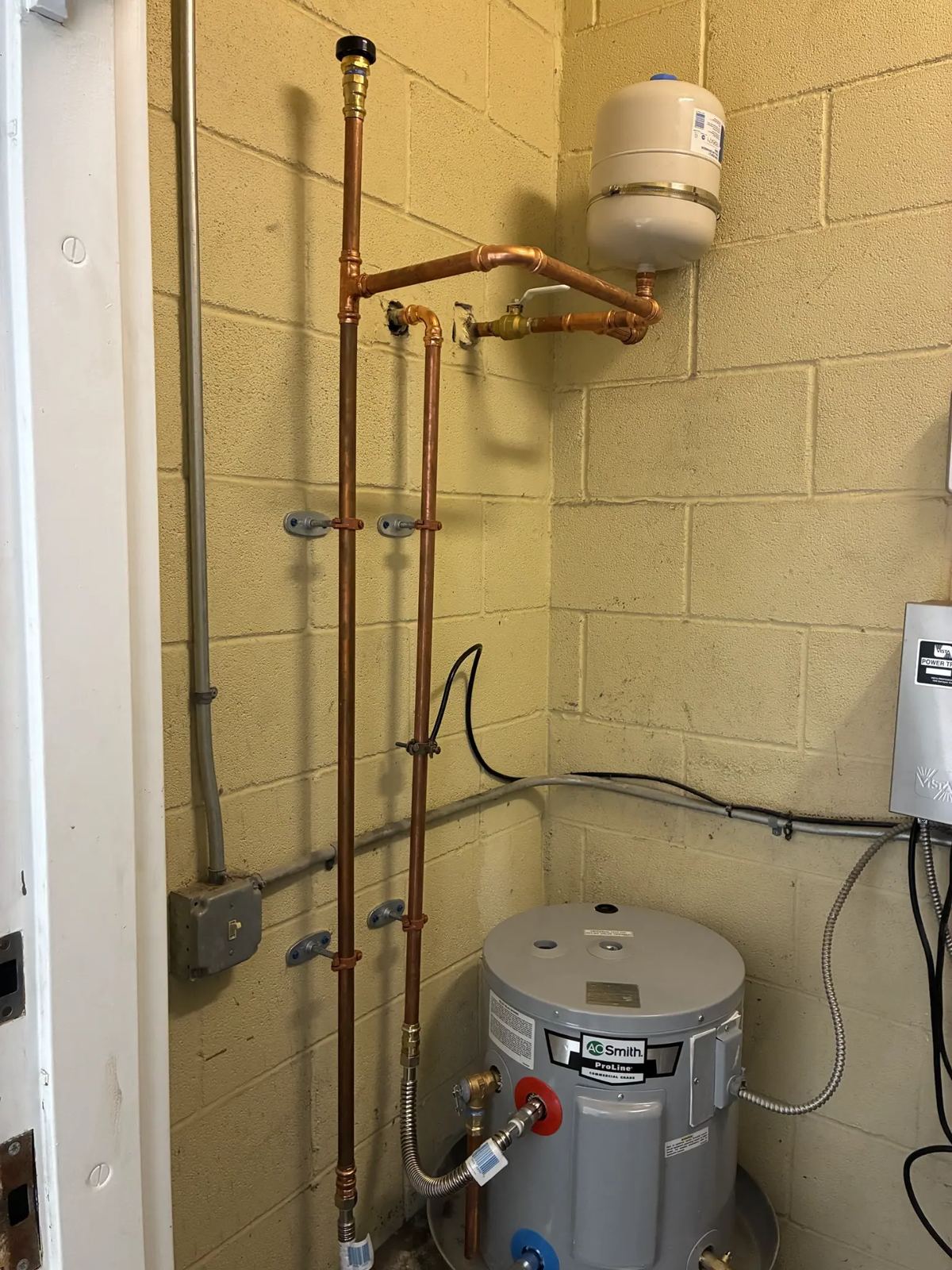 Electric water heater with thermal expansion tank and new copper piping installed in Frisco, TX